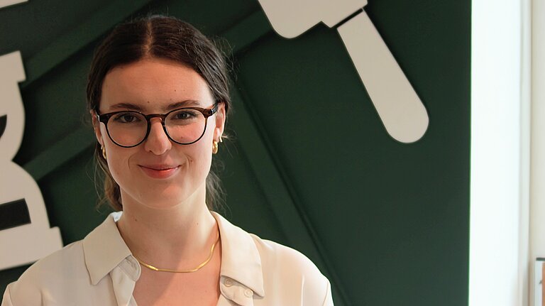 Sarah, a white woman with brown hair and glasses